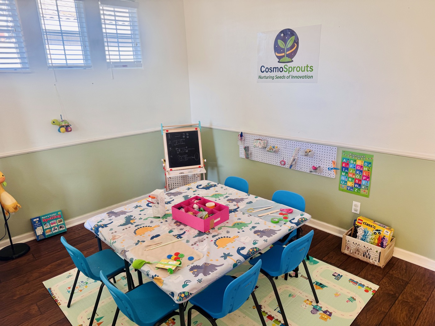 CosmoSprouts making space with craft supplies and a chalkboard